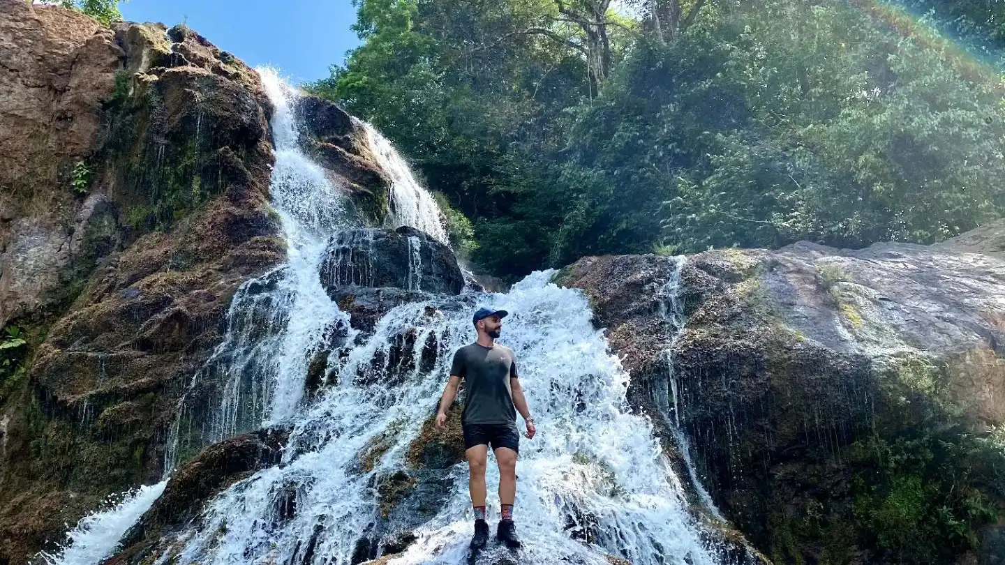 Un hombre frente a una cascada