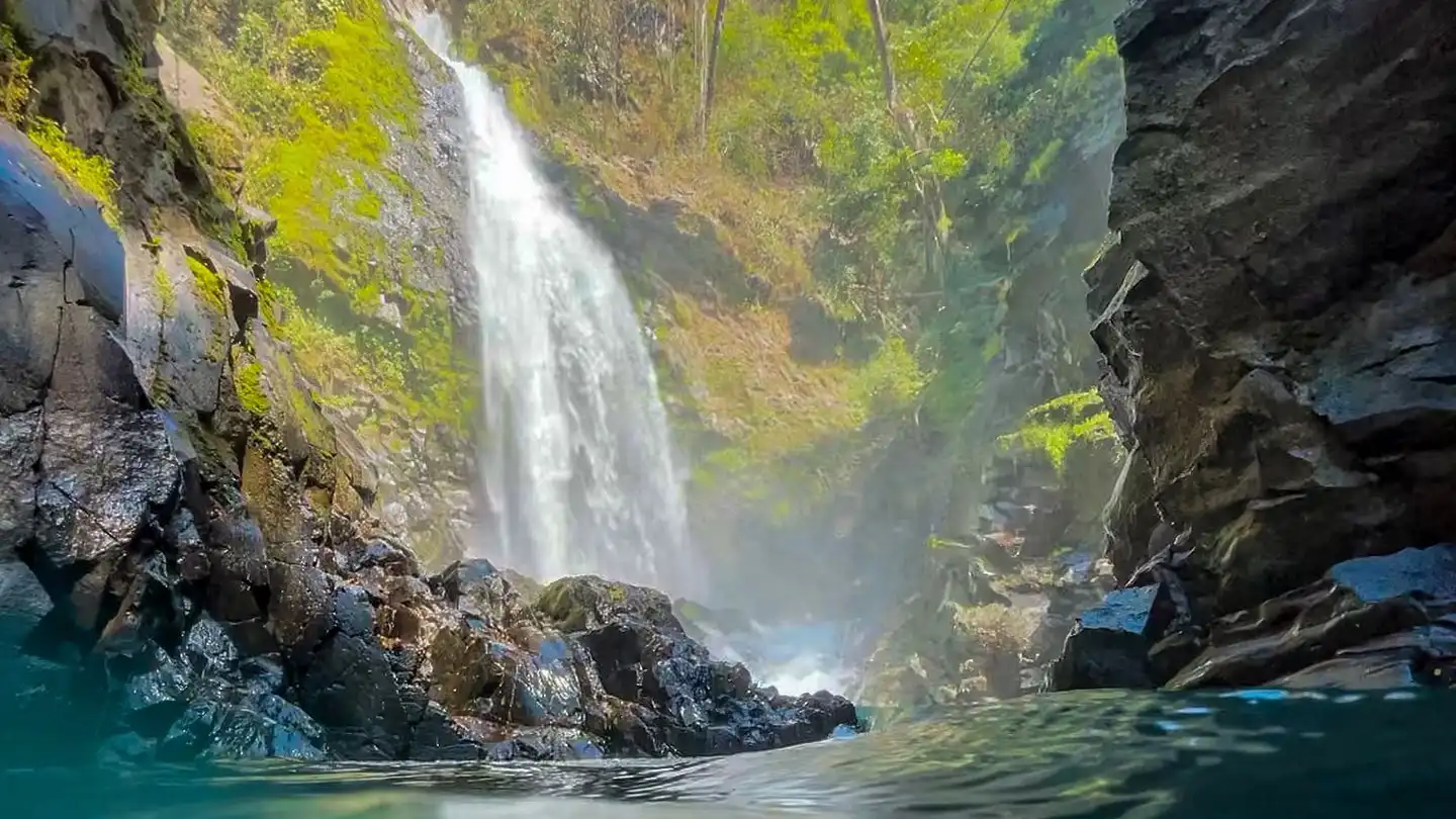 Una cascada en medio de una masa de agua.