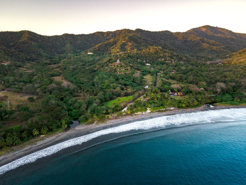 Una playa y montañas a vista de pájaro.